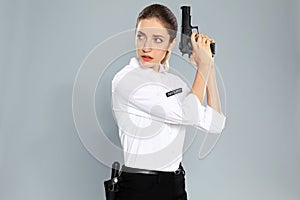 Female security guard in uniform with gun