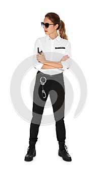 Female security guard in uniform with portable radio transmitter on background