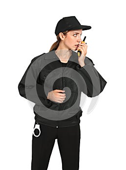 Female security guard in uniform using portable radio transmitter on background