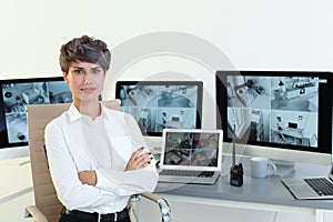 Female security guard at workplace with modern computers