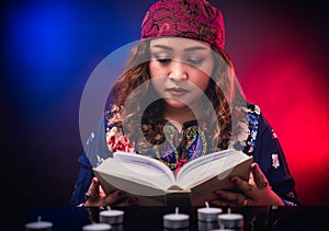 Female seer teller doing psychic reading book