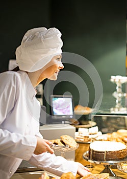 Female selling pastry and baguettes