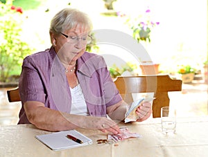 Female senior calculating her money photo
