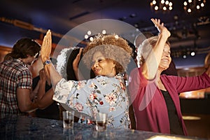 Female Senior Friends Dancing In Bar Together