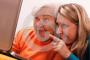 Female senior with laptop is having fun