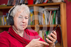 Female senior is listen musik