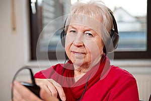 Female senior is listen musik
