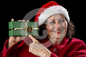 Female Senior Pointing at Green Wrapped Present