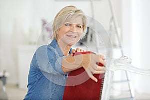 Female senior repairing chair photo