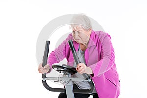 Female senior with thumb up train with fitness machine