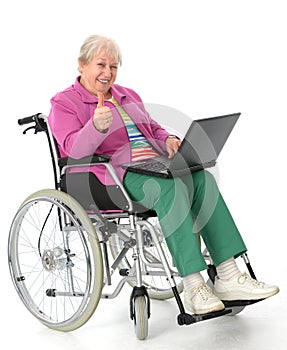 Female senior in wheelchair with computer