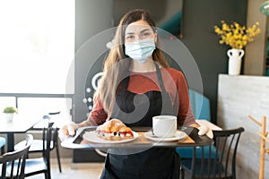 Female Server With Order In Tray At Cafe