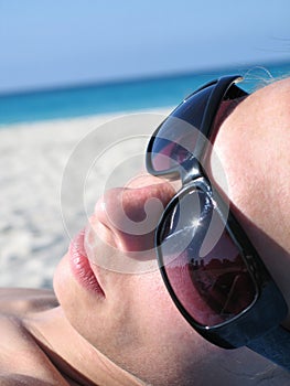 Female with shades on the beach