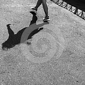 Female shadow on the pavement in BW