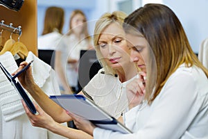 female shop assistants checking stock