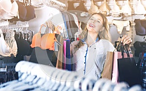 Female shopper boasting her purchases in underwear shop