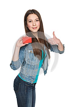 Female showing blank credit card and gesturing thumb up