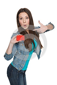 Female showing blank credit card and pointing at it