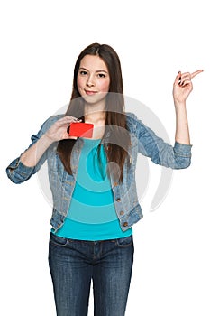 Female showing blank credit card and pointing to side