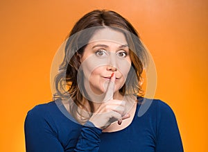 Female showing hand silence sign