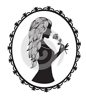 Female silhouette with long hair holds a rose photo