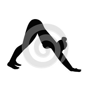 Female silhouette in yoga pose downward facing dog