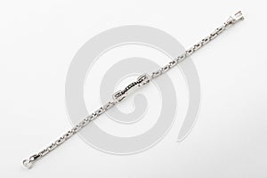 Female silver shiny bracelet with black and white stones isolated on white background.