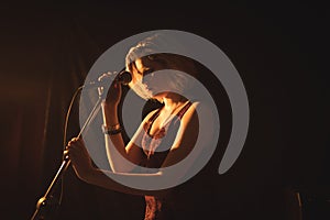 Female singer holding microphone in nightclub