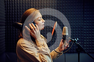 Female singer sings a song, recording studio