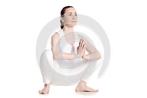 Female sitting in yoga squat