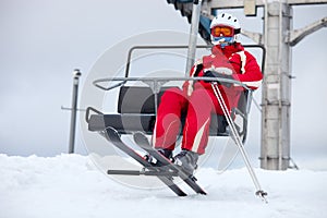 Female skier on chair-lift