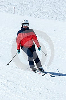 Female skier in downhill slope. Winter sport recreational activity