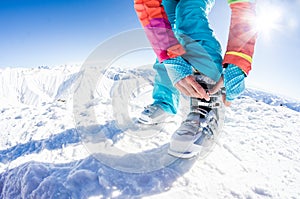 Female skier fastening her boots