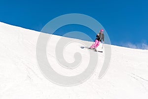 Female skier in fresh powder snow and blue sky