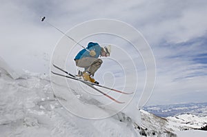 Female Skier Jumping Off Icy Overhang