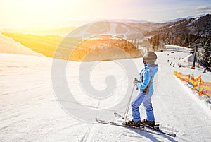 Female skier on the middle of ski slope against ski-lift