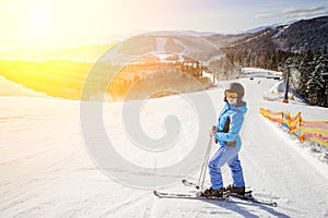 Female skier on the middle of ski slope against ski-lift