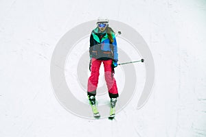 Female skier skiing down the hill in Bukovel, Ukraine