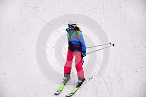Female skier skiing down the hill in Bukovel, Ukraine