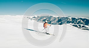 Female Skier skiing in mountain ski resort. Winter sport recreational activity