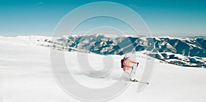 Female Skier skiing in mountain ski resort. Winter sport recreational activity