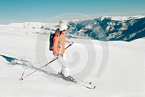 Female Skier skiing in mountain ski resort. Winter sport recreational activity