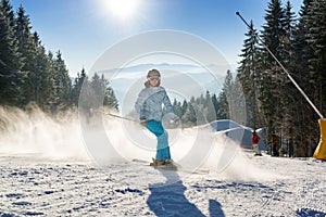 Female skier skiing with snow powder