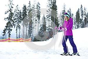 Female skier on slope at resort, space for text.