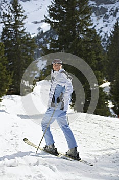 Female Skier Standing On Ski Slope