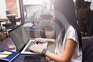 Female skilled copywriter connected to wifi via laptop computer during remote job
