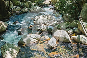 Female slackliner walking a highline over a waterfall
