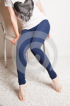 Female slender legs in sports leggings