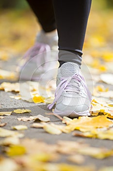 Female sneakers on the pave in a start position