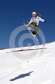 Female snowboarder jump shadow